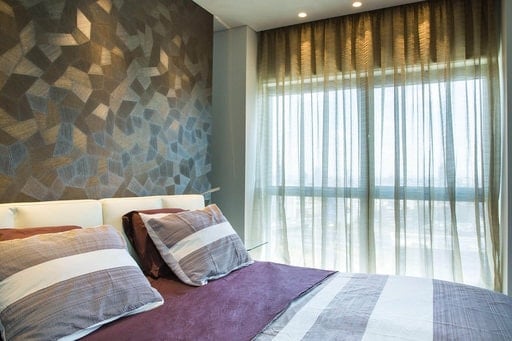 A perfect paring of wallpaper and curtains, creating visual harmony in the bedroom